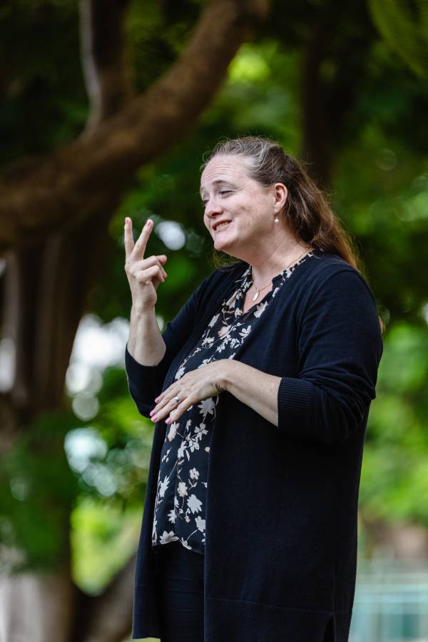Woman using sign language at the SLAm! 43 Conference in Barbados.